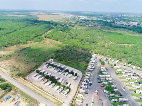 High aerial view showing Vaquero RV Park and the adjacent brush land planned for Phase 2